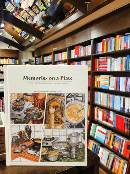 Our book, 'Memories on a Plate', sitting proudly on the shelves of a bookstore. It's a collection of stories from 100 Indian kitchens around the globe.