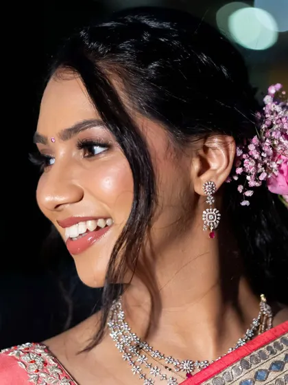 A detailed shot of her reception makeup. I focused on creating a flawless, glowing complexion and a bright, happy smile.
