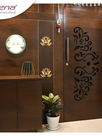 A beautiful wooden entrance door with a laser-cut floral pattern. We complemented it with a matching shoe cabinet and a backlit nameplate for a complete and welcoming look.