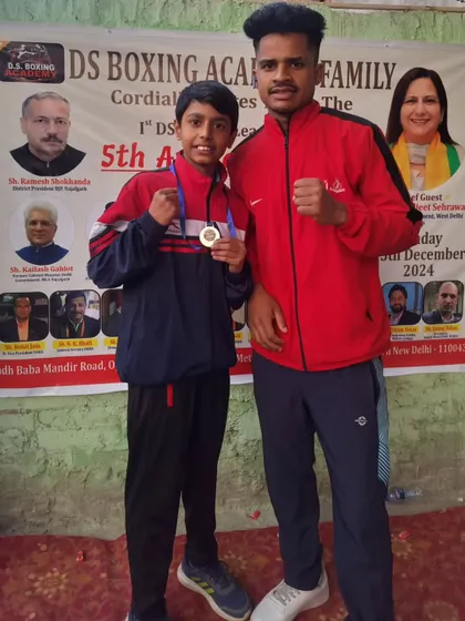 A student boxer and his coach after a win at the DS Boxing League. The bond between a coach and a boxer is key to success.