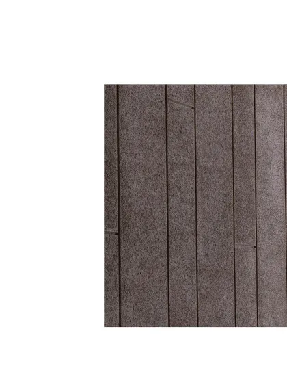 A close-up of a textured wall finish. The subtle grooves and dark wood grain demonstrate how material selection and detailed execution can cultivate an elevated and tactile spatial experience.
