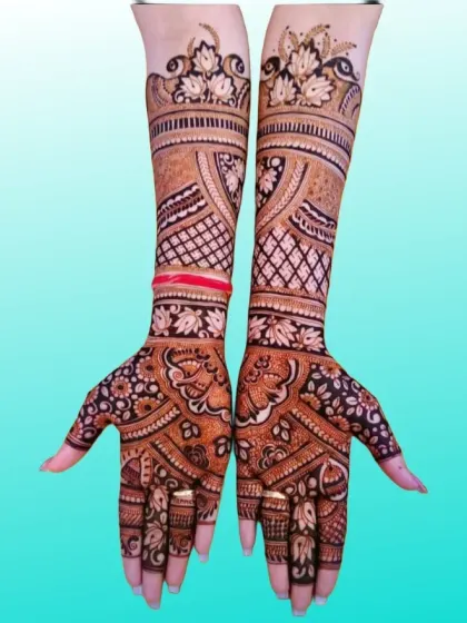 A graceful and flowing design with leafy vines and floral patterns extending up the arm, perfect for a modern yet traditional bride.