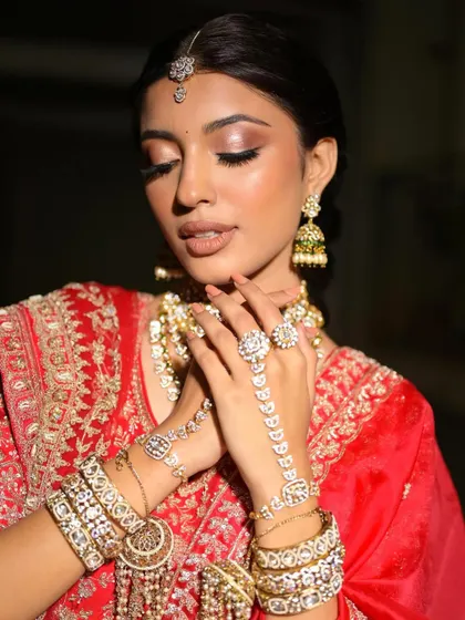 A dreamy and romantic shot. The soft lighting highlights the glowing skin and the subtle shimmer on her eyes.