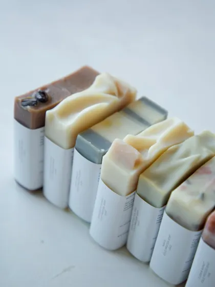 A side view of the assorted soaps for the baby shower, showing the beautiful textures and natural colors of each bar.
