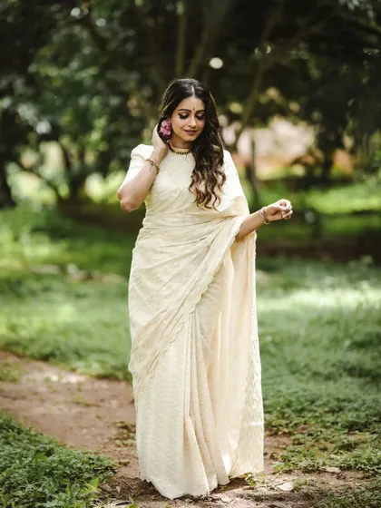 Another beautiful shot from the Onam fashion series. The full-length view captures the complete look, showing how the traditional attire flows gracefully in a natural, green setting.