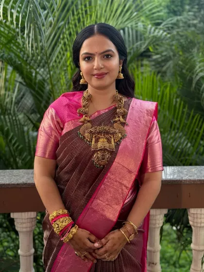 An elegant guest look for a wedding. She is wearing a beautiful silk saree, and I gave her a soft, natural makeup look with her hair styled in simple waves, adorned with roses.