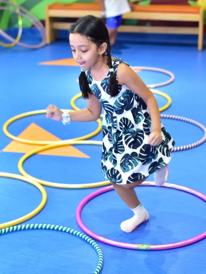 Hopping through hoops is a fun challenge in our active camps. I use colorful equipment to create engaging obstacle courses that help develop balance and gross motor skills in a playful setting.