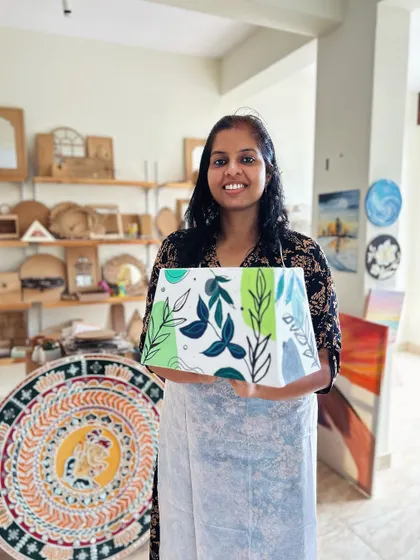 A proud artist with her finished botanical-themed lampshade.