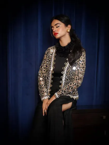 A moody, contemplative pose with the mirror-work jacket. The vignette effect draws all the attention to the model and the intricate details of the jacket.