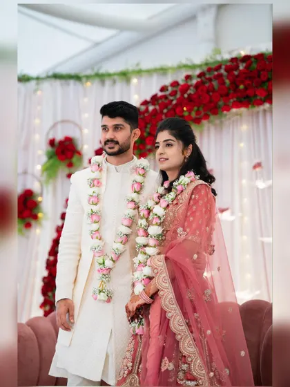 The happy couple posing after their engagement. Our decor included custom floral garlands that matched the pink and red theme of the stage backdrop.
