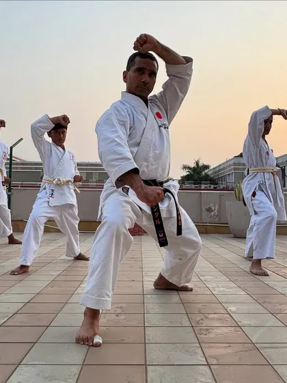 We also take our training outdoors to connect with our environment and practice in different settings. Here, I lead a group of students through their forms, reinforcing that the principles of karate can be applied anywhere.