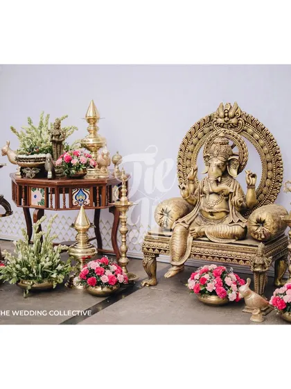 To honor tradition, we created a sacred space featuring a beautiful Ganesha idol on an ornate throne. The area is decorated with antique brass lamps and bowls of fresh pink flowers, blending spiritual significance with aesthetic beauty.