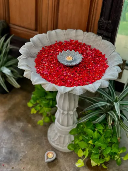 A beautiful stone uruli filled with flowers, creating a charming and traditional welcome. You can see these and many more decor pieces at my lake store, where nature and handmade art come together.