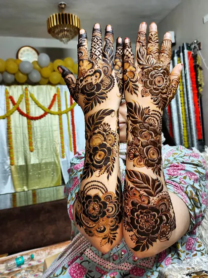 The full view of this intricate floral piece, showing the detailed work on the fingers and palms.
