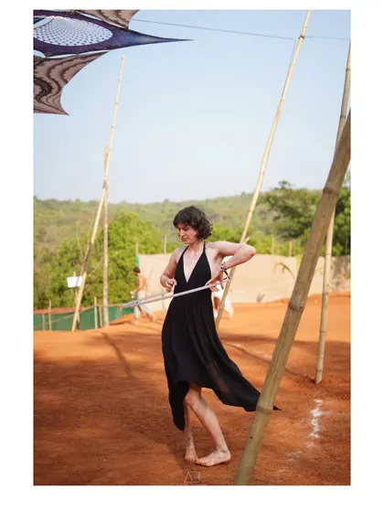 A woman hula-hooping at a festival. This candid shot captures a moment of playful skill and grace.