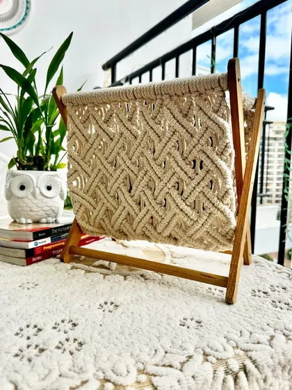 The magazine holder looks beautiful on a balcony, adding a touch of handmade texture to an outdoor space.