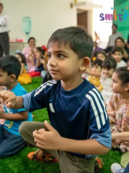 A young boy in the audience is captivated by the performances on stage. Our events are engaging for the entire Smiti family.