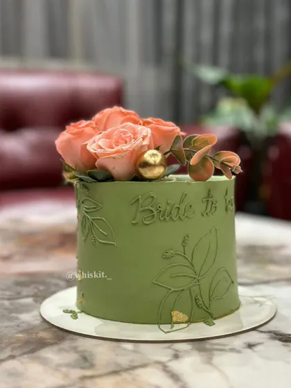 A close-up of the hand-etched details on the sage green cake. This technique adds a layer of texture and artistry that makes the design truly special.