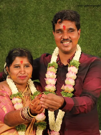 A simple and happy portrait of the couple after their wedding ceremony. Their smiles and the traditional garlands represent the joy of their union.