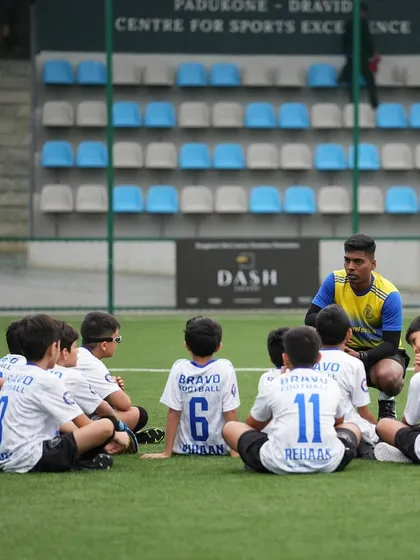 A coach's huddle with the U11s during the DPDL Super Cup. A moment of focus and strategy.