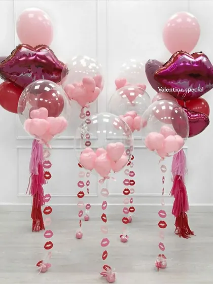 It's all in the details. This Valentine's special setup features lip shaped foil balloons and bubble balloons filled with tiny hearts, with hanging paper lip cutouts for extra flair.