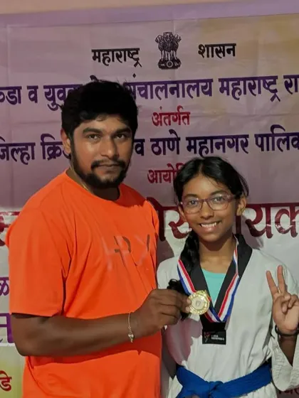 Here I am with my student Yohansh Vyas, who won a silver medal at the DSO competition. His performance was fantastic, and he is making the victory sign, ready for the next challenge.
