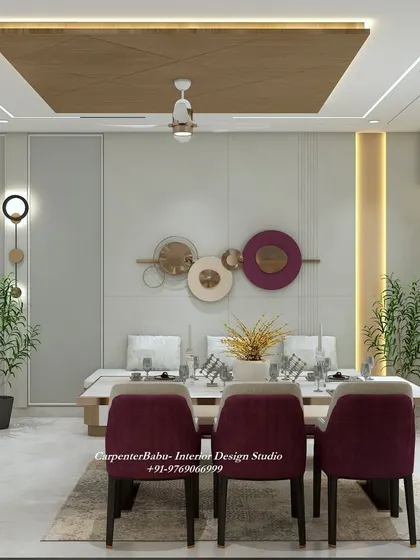 The dining table is set against a wall with circular metal art, adding a pop of color and a modern artistic touch. The bench seating is a great space-saving solution.
