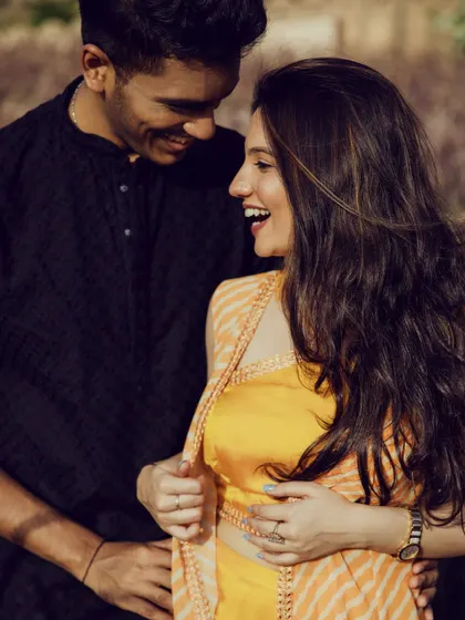Laughter and love. This candid shot captures the joy of the moment, with her makeup looking natural, radiant, and effortlessly beautiful.