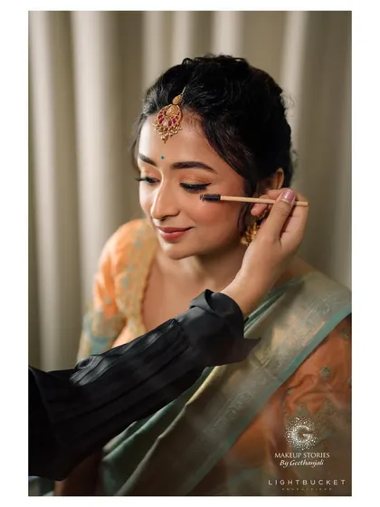 A behind the scenes moment, applying finishing touches to Harshitha's eye makeup. Precision and a gentle hand are crucial techniques we practice extensively in my makeup workshop.