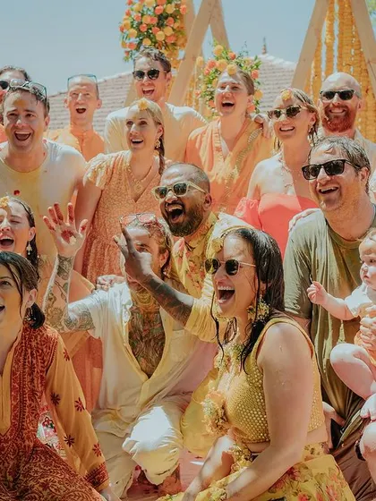 The whole family joins in the fun, showering the couple with love and petals. This image is a beautiful testament to the joy and togetherness of a Haldi ceremony.