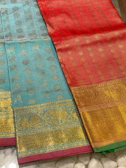 A sky blue and a red Kanjeevaram blouse piece, each with unique animal motifs woven in gold zari. These are the special finds I love to bring back from my travels.