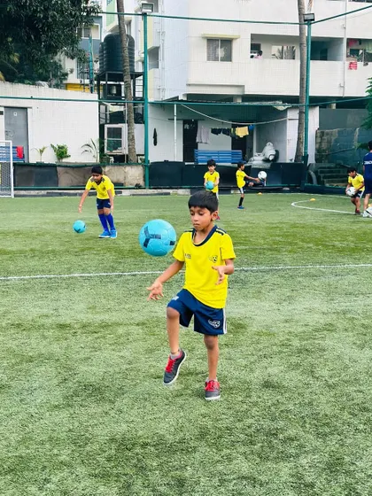 A young player practices his juggling skills. Ball mastery is a continuous focus in our program, helping players build a strong connection with the ball.