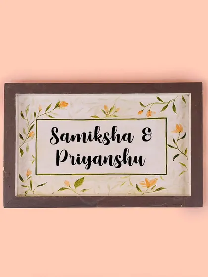 A personalized nameplate for a couple, featuring our signature hand-painted floral border. This design is perfect for new homes and makes a wonderful housewarming gift.