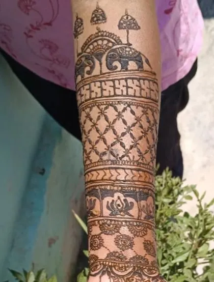 Another angle of the forearm, showing the detail in the elephant motifs and the lotus band.