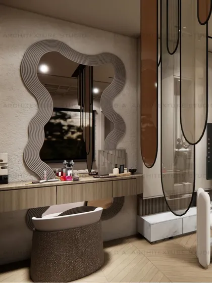A detail shot of the wavy, custom-framed mirror and vanity table, highlighting the playful yet elegant curves used throughout the space.