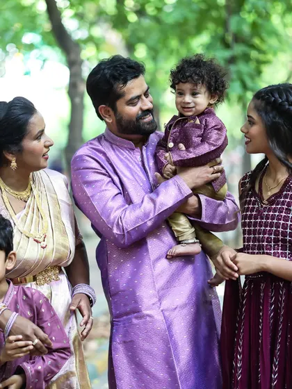 A candid family portrait taken outdoors. I love capturing the natural interactions between parents and their children in a relaxed setting.