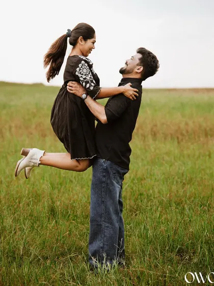 A joyful lift in a green field, this pre-wedding photo is full of energy and happiness.