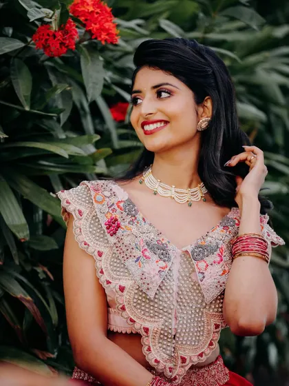 Rishika in a beautiful red and pink lehenga. This vibrant look is perfect for a Sangeet or Mehendi guest.