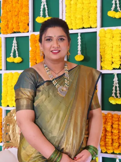 A full portrait of this glowing mama-to-be at her baby shower. The makeup is soft and understated, perfectly complementing her traditional attire and the happy occasion.
