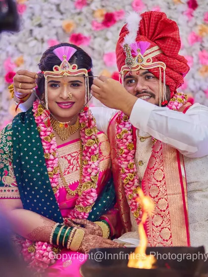 A sweet, helpful gesture from the groom as he adjusts the bride's Mundavalya. These small acts of care make for wonderful, candid photographs.