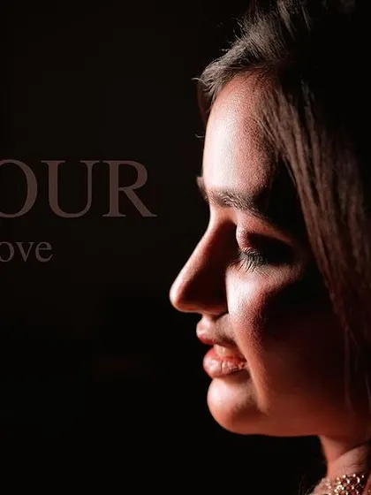 A beautiful profile shot with artistic lighting, showcasing the clean lines and soft finish of the engagement makeup.
