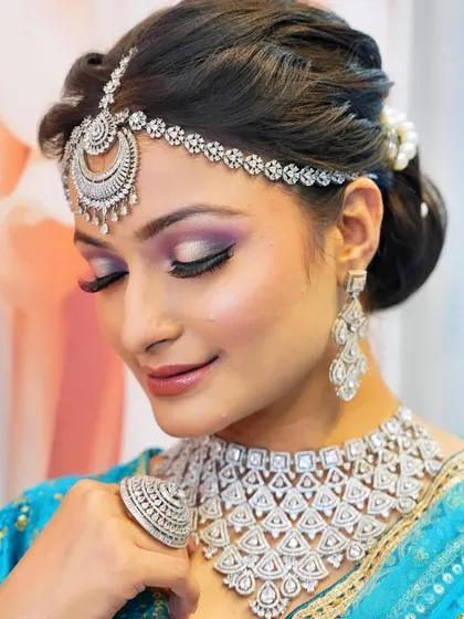 A glamorous reception look featuring a purple smokey eye and diamond jewelry. You will learn to pair makeup with different types of jewelry, from kundan to diamonds.
