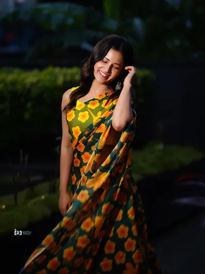 The beauty of a simple, printed saree. The motion in the fabric and the subject's happy expression make this a lively and joyful outdoor portrait.