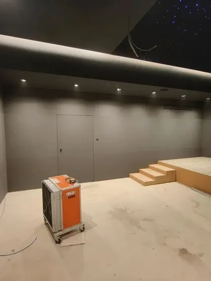An early stage of construction. The basic shape of the room is defined, and the platform for the tiered seating is being built. The star ceiling panel is already in place.