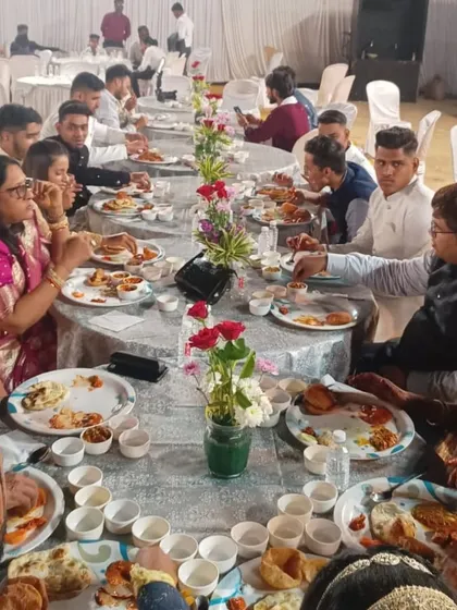 Guests seated and enjoying their meal at a wedding featuring my royal setup. I can arrange for elegant table settings that match the grandeur of the buffet.