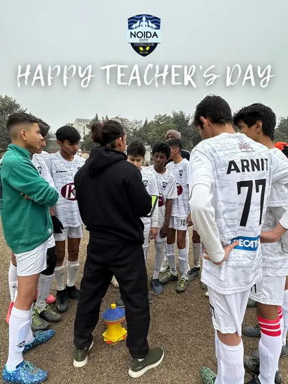 A coach huddles with his team, teaching the importance of teamwork, resilience, and passion. Our coaches are mentors on and off the pitch.
