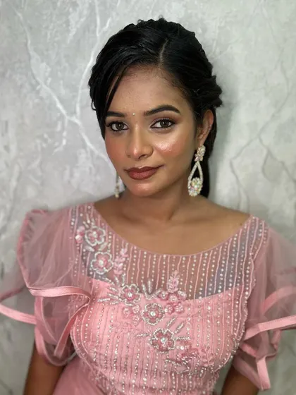 A close-up portrait indoors, showing the soft and blended eyeshadow and the overall polished finish of the makeup.