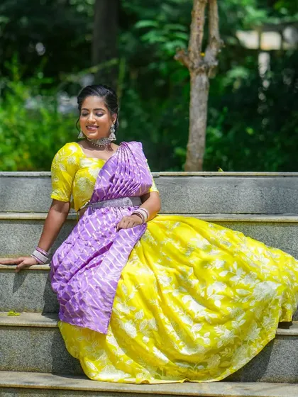 A client celebrating Navaratri Day 1 in a bright yellow and purple half saree.