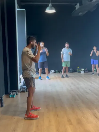 A coach demonstrating the proper stance during our workshop at The Courtyard Community.
