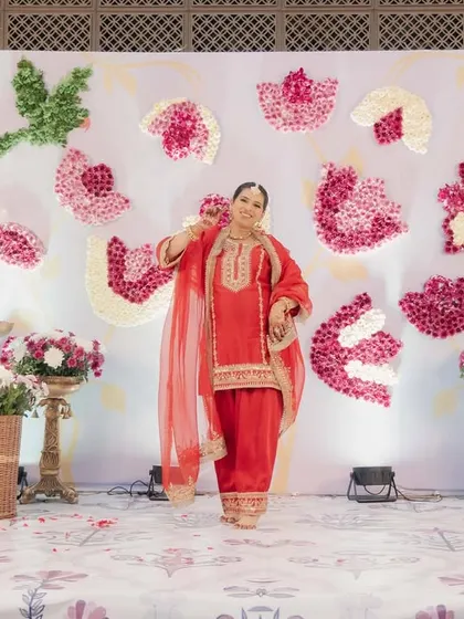 The radiant mom-to-be, perfectly framed by the floral lotus decor we created for her special day.